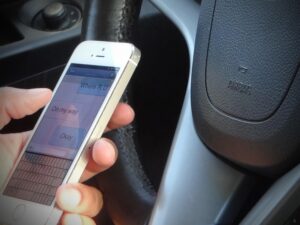 driver distracted while using white cell phone