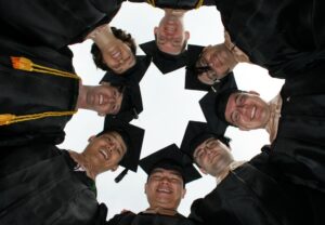 group of graduates with their heads in a circle