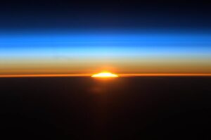 small sliver of sunrise on the blue & black horizon