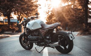 motorcycle parked on street with sunset in the background