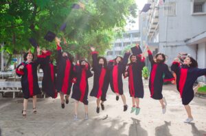 group of graduates jumping into the air in celebration