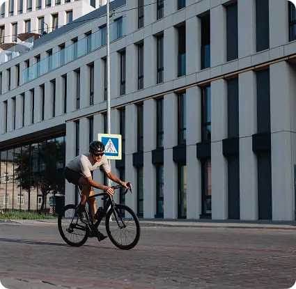 Active man riding bike on city street