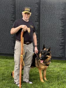 Vietnam Veteran and his service dog at the Wall of Healing