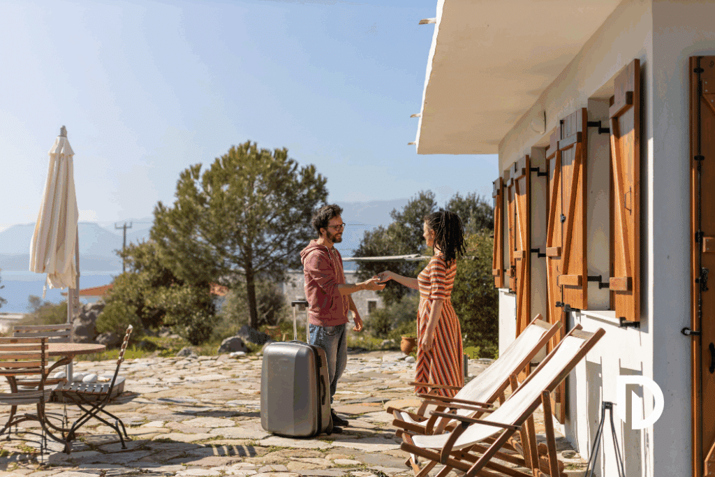 man getting the keys to a vacation home airbnb from the host
