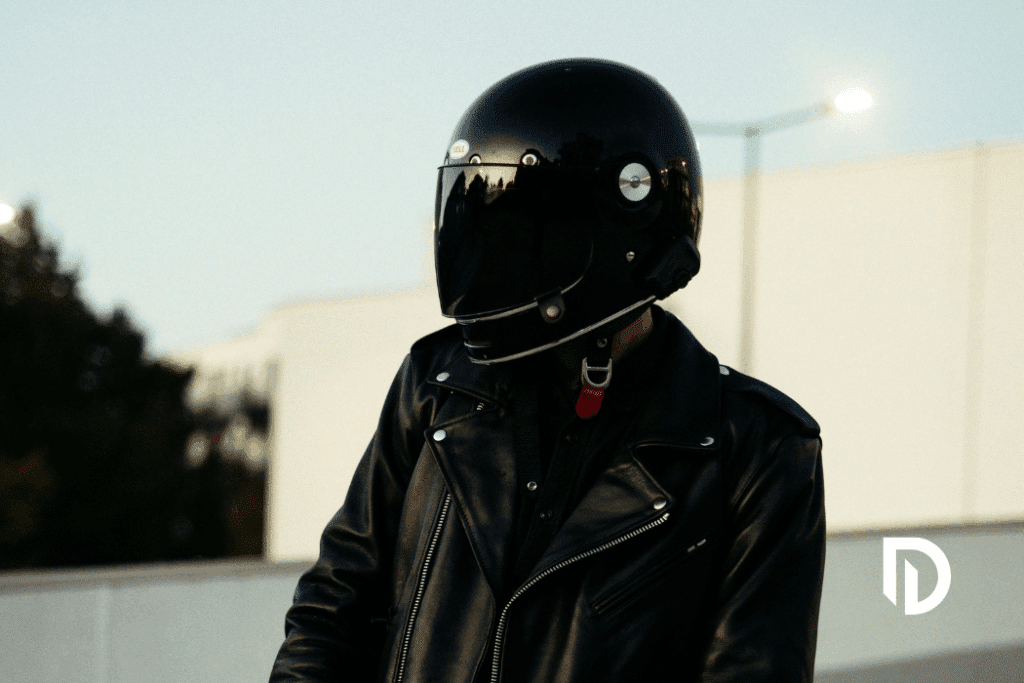 motorcyclist wearing a black helmet and black leather jacket