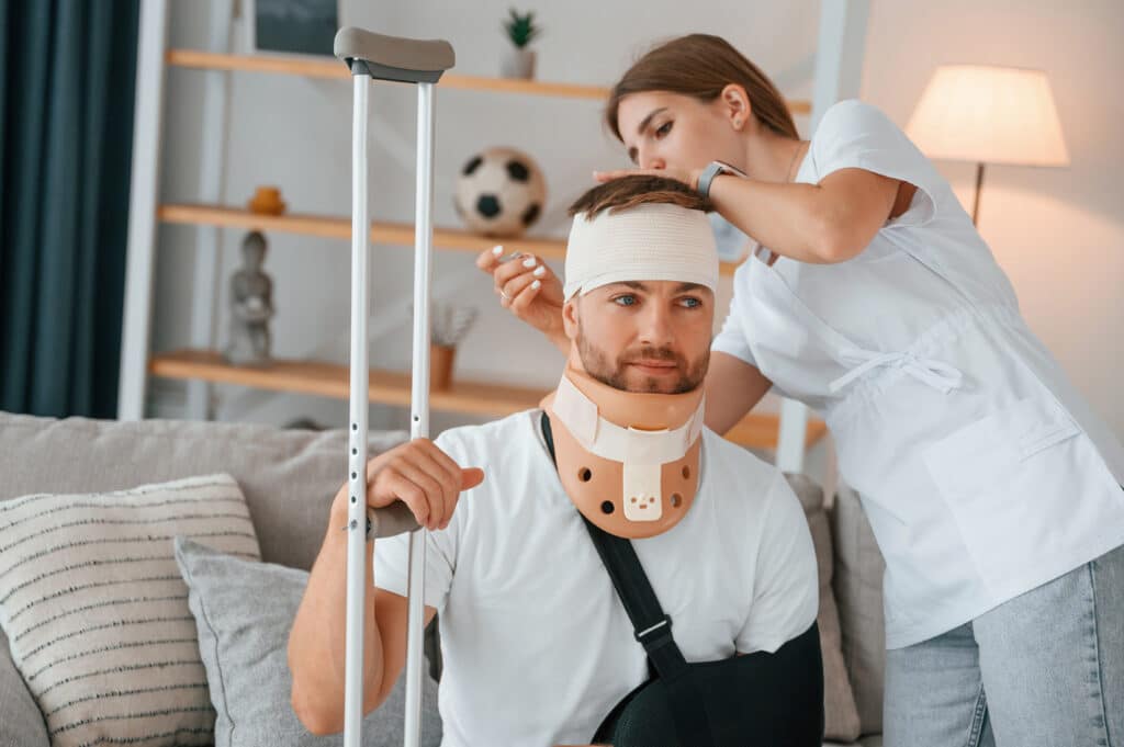 taking care of bandage on the head of a man after an injury