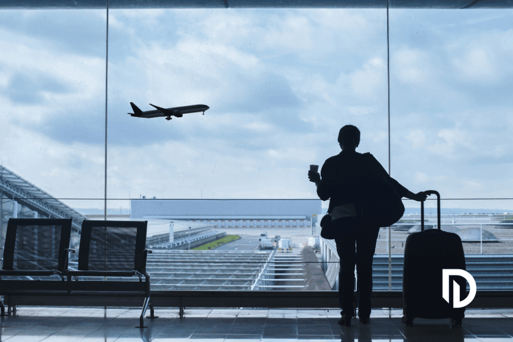tourist watching a plane take off from the Boston airport because they traveled there