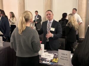 Chris DiBella speaking with student at event