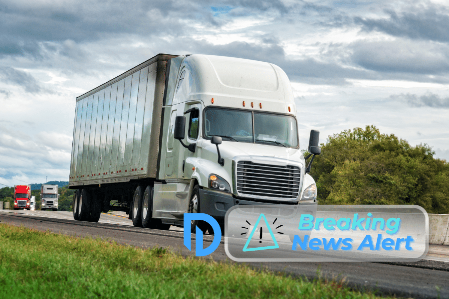 A white semi-truck driving on a highway