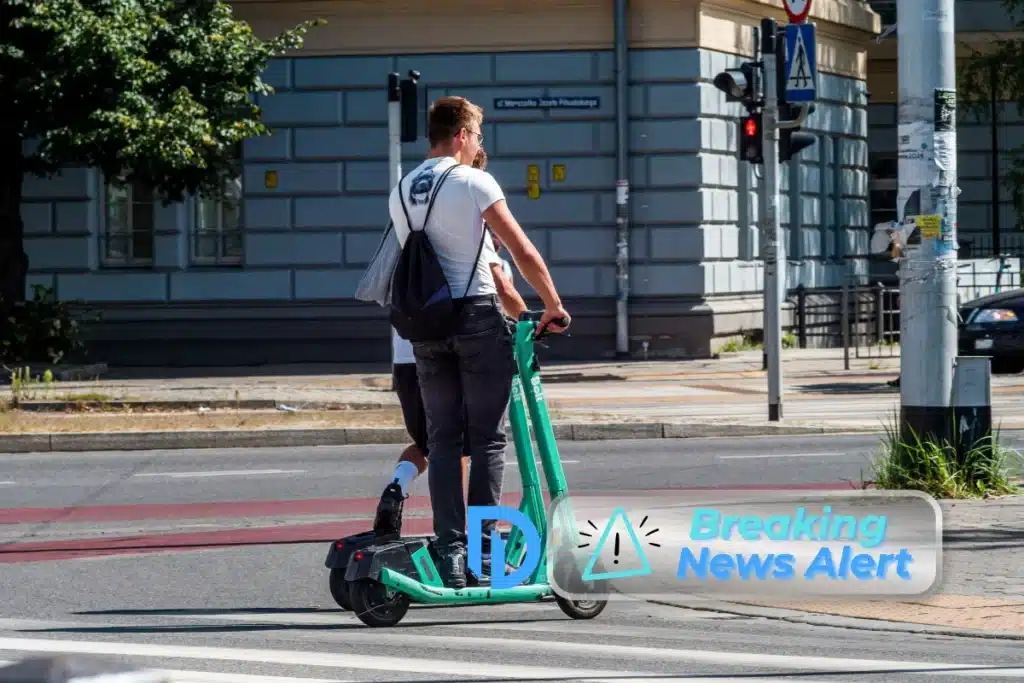 two people riding electric scooters in Boston, MA