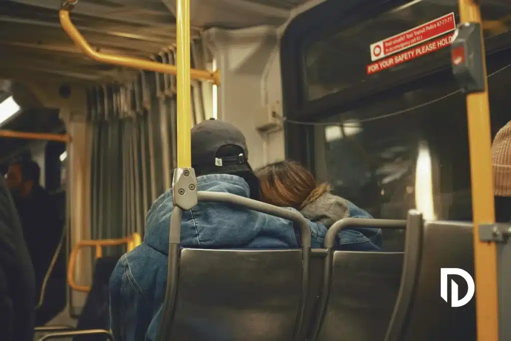 a couple traveling on an MBTA bus in Boston