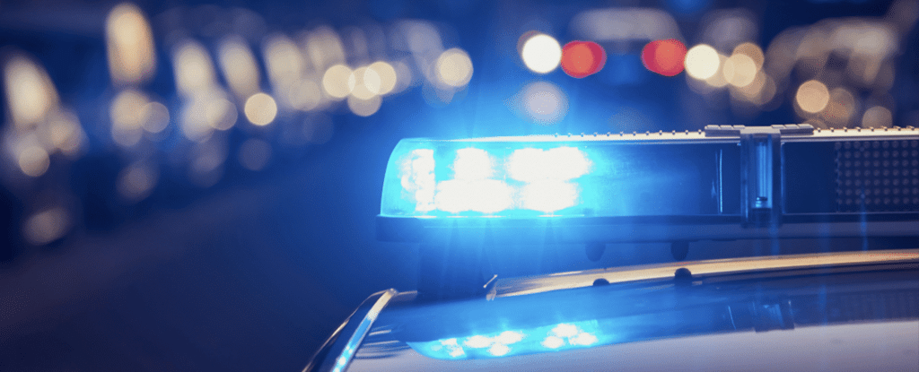 close up of the top of a boston police car at night. Sirens are blue