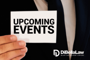 A man holding a piece of paper that says "upcoming events."