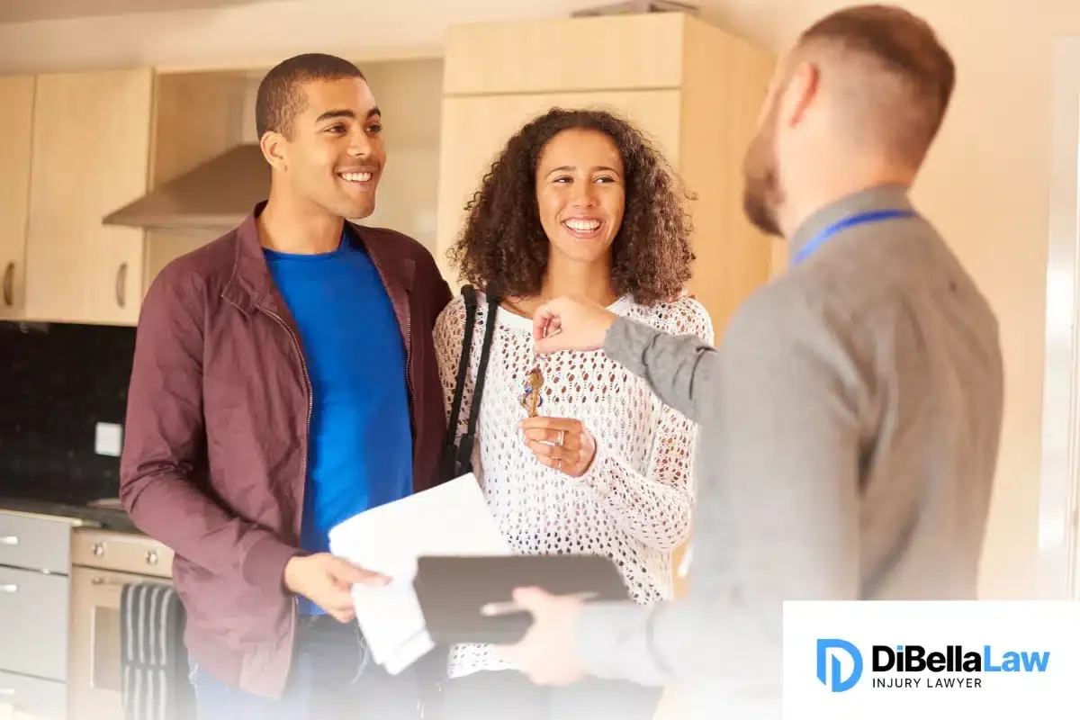 A young couple receive the keys to their new apartment from a landlord